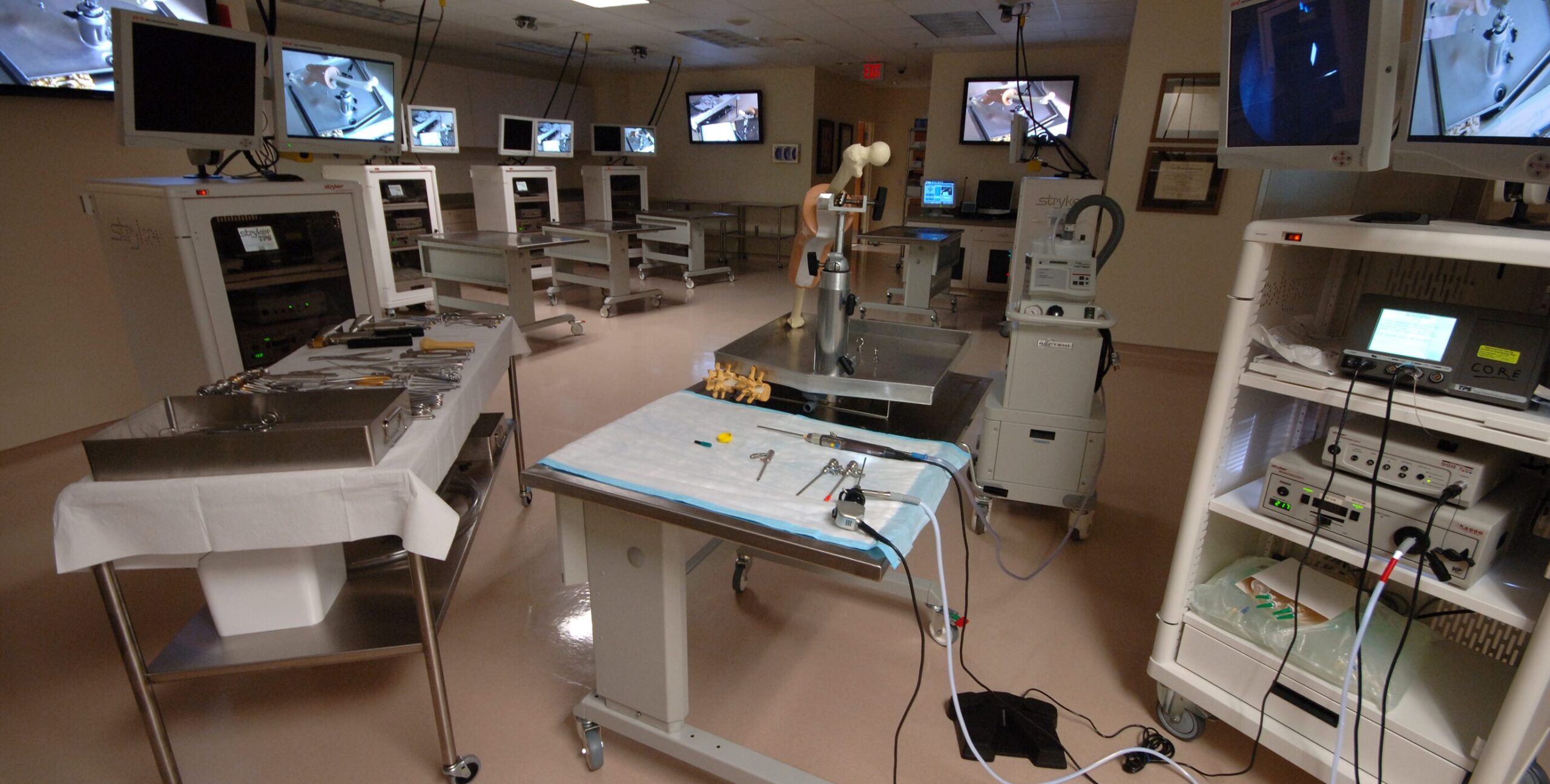 A wide image of the UF Surgical Skills Lab prepped for a knee procedure with a surgical model on a table.